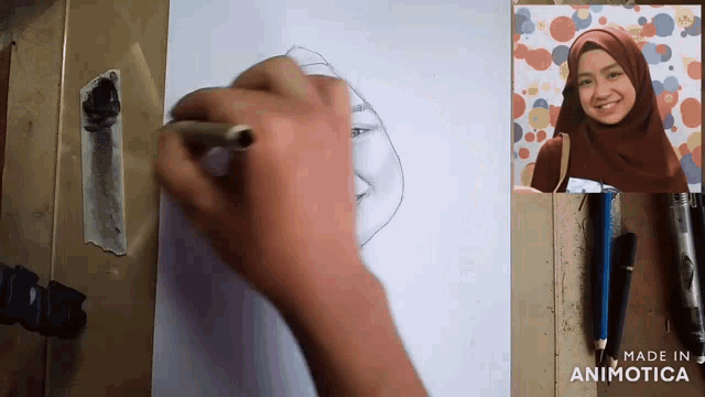 a person is drawing a picture of a girl with the words made in animotica on the bottom