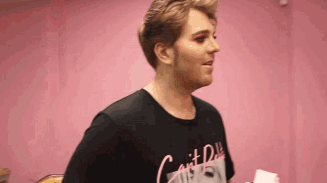 a man wearing a black t-shirt that says " can 't do "