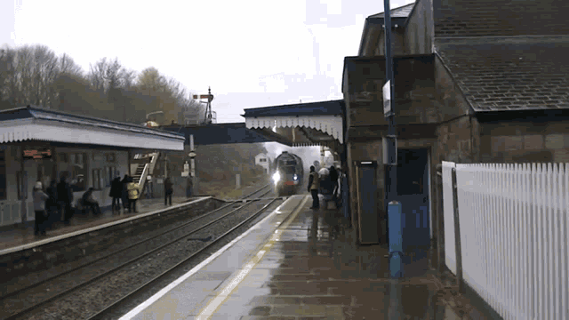 a train is coming down the tracks at a station