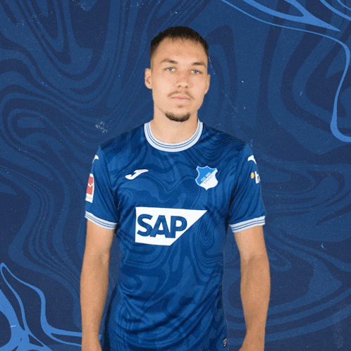 a man wearing a blue shirt with the word sap on the front