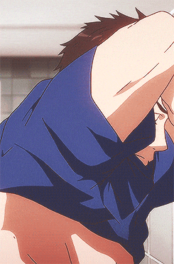 a man in a blue shirt is stretching his arm