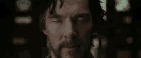a close up of a man with a beard making a face .