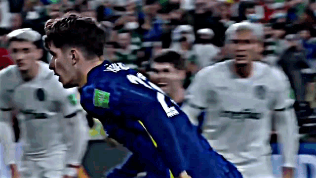 a soccer player wearing a blue jersey with the number 21 on the back