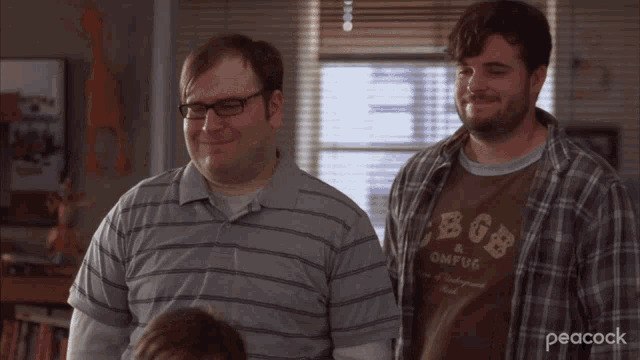 two men are standing next to each other and one is wearing a shirt that says cbgb