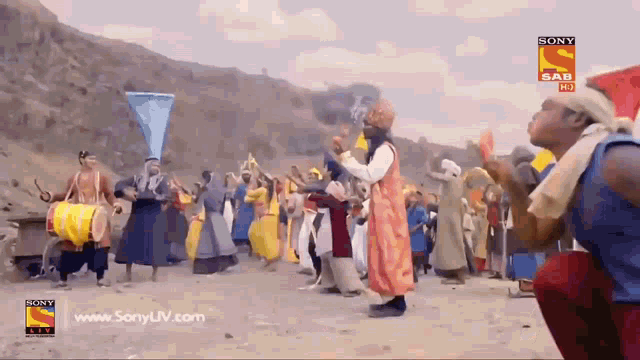 a group of people are dancing in front of a sony advertisement