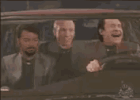 three men are laughing while sitting in a car
