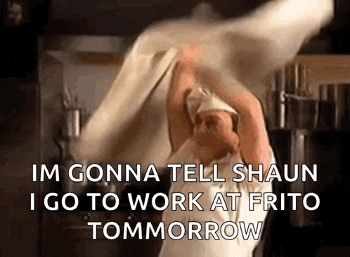 a man in a chef 's apron is throwing a piece of dough in the air