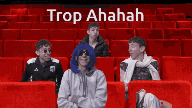 a group of people sitting in red seats with the words trop ahahah on the bottom