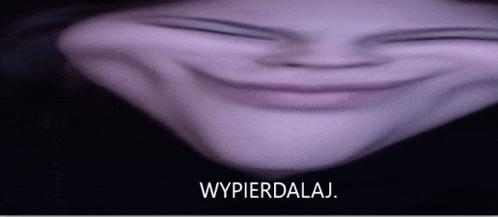 a blurry picture of a person 's face with the words wypierdalaj written below it