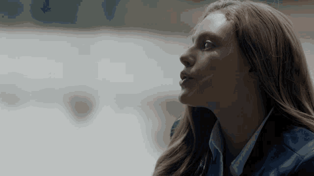 a close up of a woman 's face looking up
