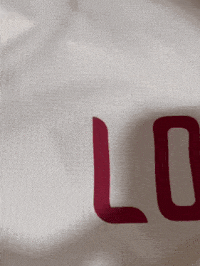 a close up of a white shirt with red letters that says lo