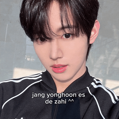 a young man wearing a black jacket with the words jang yonghoon es de zahi on the bottom
