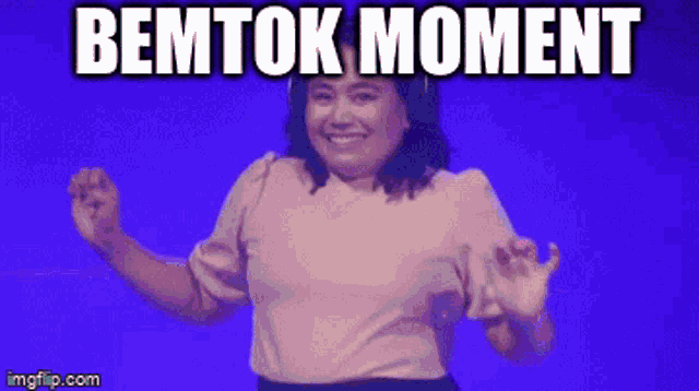a woman is dancing in front of a blue background with the words bemtok moment above her
