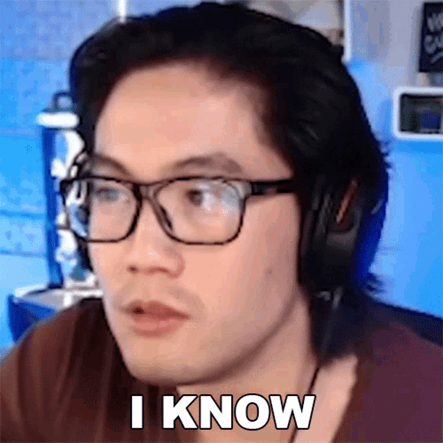 a man wearing glasses and headphones is saying " i know "