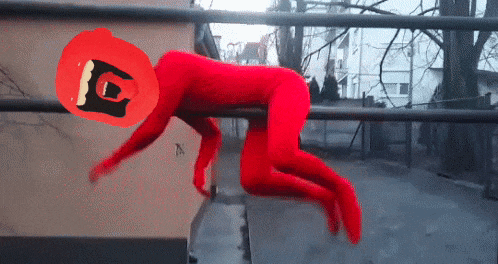a person in a red superhero costume is crawling on a bar