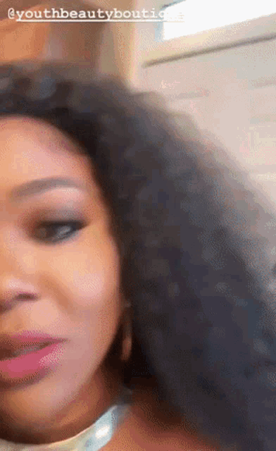 a close up of a woman 's face with the words youth beauty boutique written on the bottom