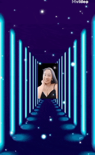 a woman in a black top is standing in a tunnel of blue lights .