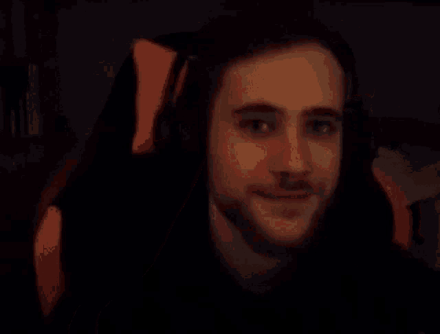 a man is giving a thumbs up sign while sitting in a gaming chair .