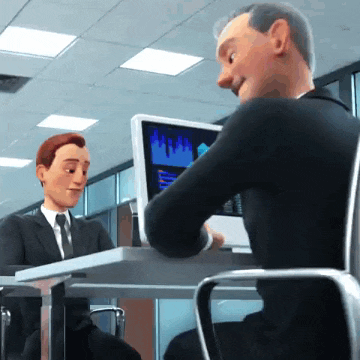 a man in a suit and tie is sitting at a desk with a laptop