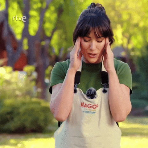 a woman wearing an apron that says ' mago ' on it holds her head
