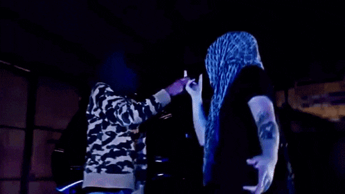a man in a leopard print shirt is standing next to another man