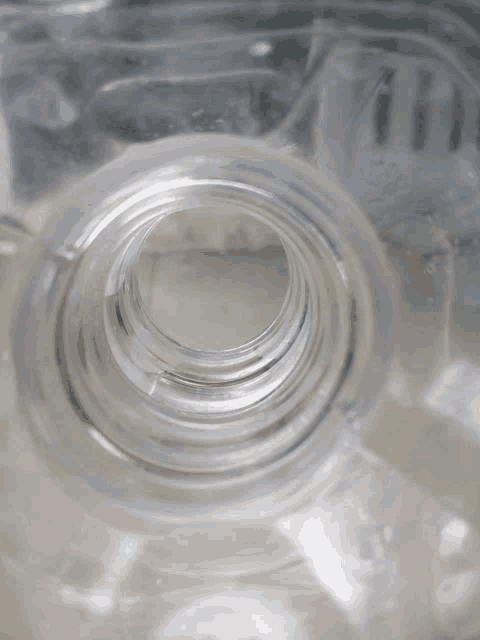 a clear plastic bottle with a hole in the middle of it