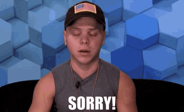a man wearing a hat and a tank top says sorry