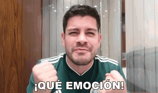 a man in a green adidas shirt is making a funny face and says que emocion