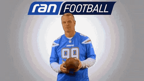 a man in a chargers jersey holds a football in front of an advertisement for ran football