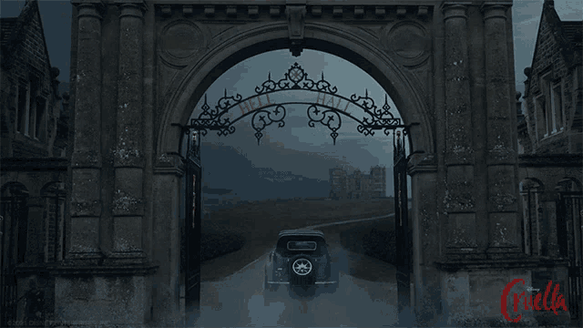 a car is driving through a gate that says " hatton hall "