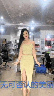 a woman in a yellow dress stands in a room with chinese writing