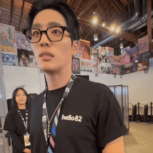 a man wearing glasses and a black shirt with hello82 on it