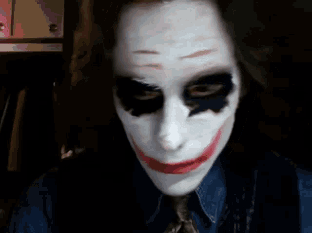 a close up of a person wearing a joker makeup