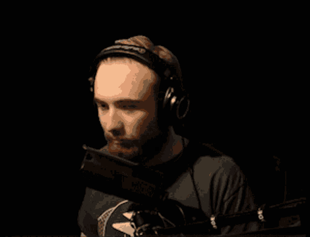a man wearing headphones stands in front of a microphone that says rode