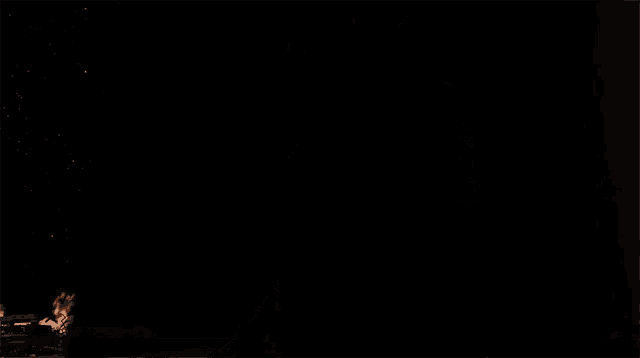 a man in a black cape stands in front of a large red planet