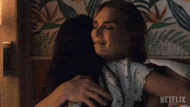 a woman hugging another woman with netflix written on the bottom