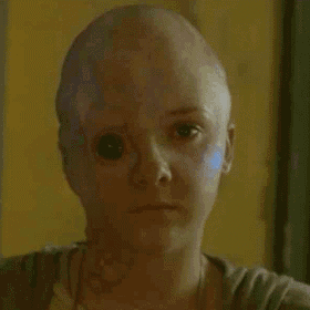 a close up of a woman 's face with a blue eye