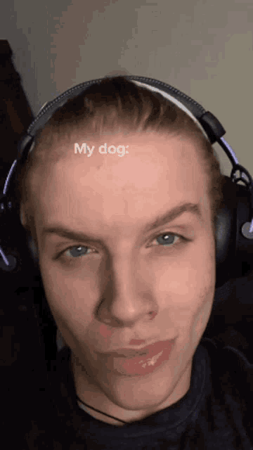 a young man wearing headphones has the word my dog on his forehead