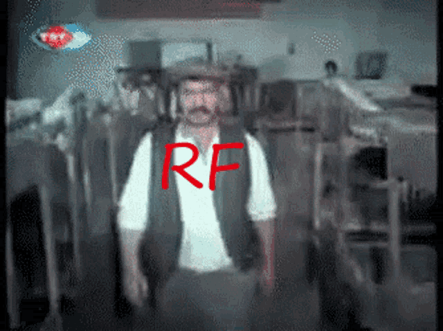 a man in a hat is standing in front of a sign that says trt on it
