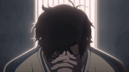 a person covering their face with their hands