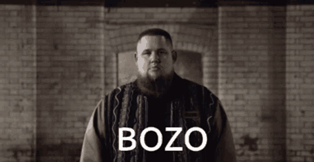 a man with a beard wearing a sweater with bozo written on it
