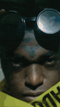 a close up of a man wearing goggles and a caution tape