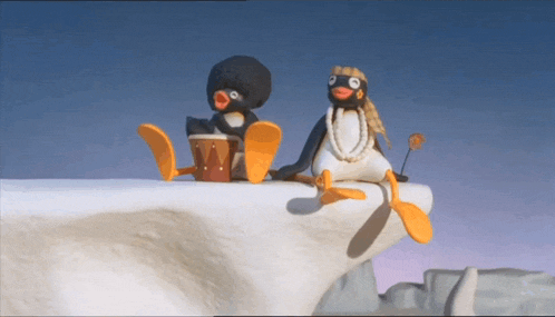 two penguins are sitting on a snowy cliff and one has a drum