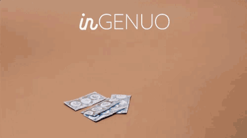 a box of kleenex sits next to a magazine on a table