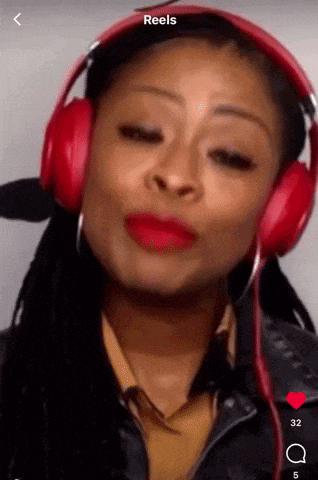 a woman wearing red headphones with the word reels on the bottom right