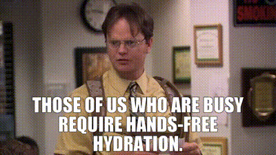 a man in a yellow shirt and tie is talking about those of us who are busy require hands - free hydration .