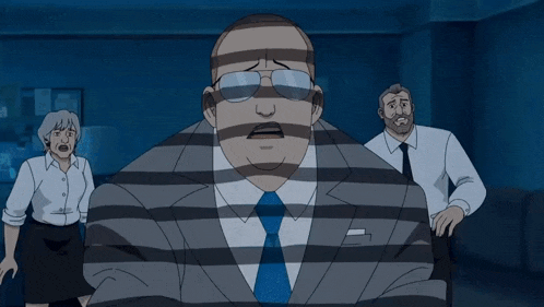 a man in a suit is laying on the ground while another man stands in the background