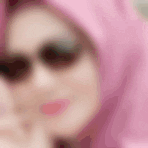 a close up of a woman 's face with pink hair