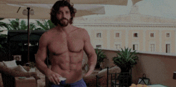 a shirtless man with a beard is standing on a balcony with an umbrella