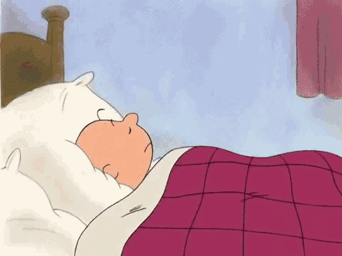 a cartoon character is sleeping on a bed with a pink blanket